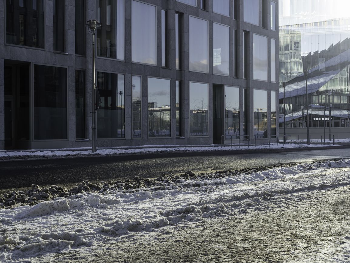 Skateboarding in Snow with Building Facade in Daylight