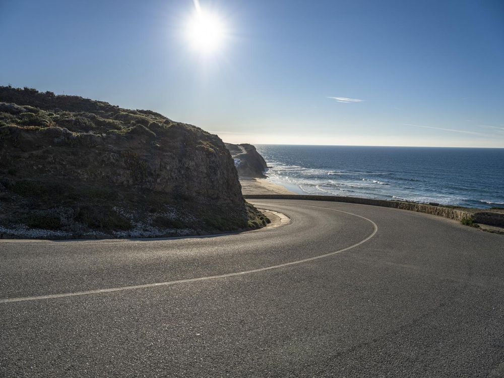 Curved Road Next to Coastal Hill with Bright Sun - HDRi Maps and Backplates