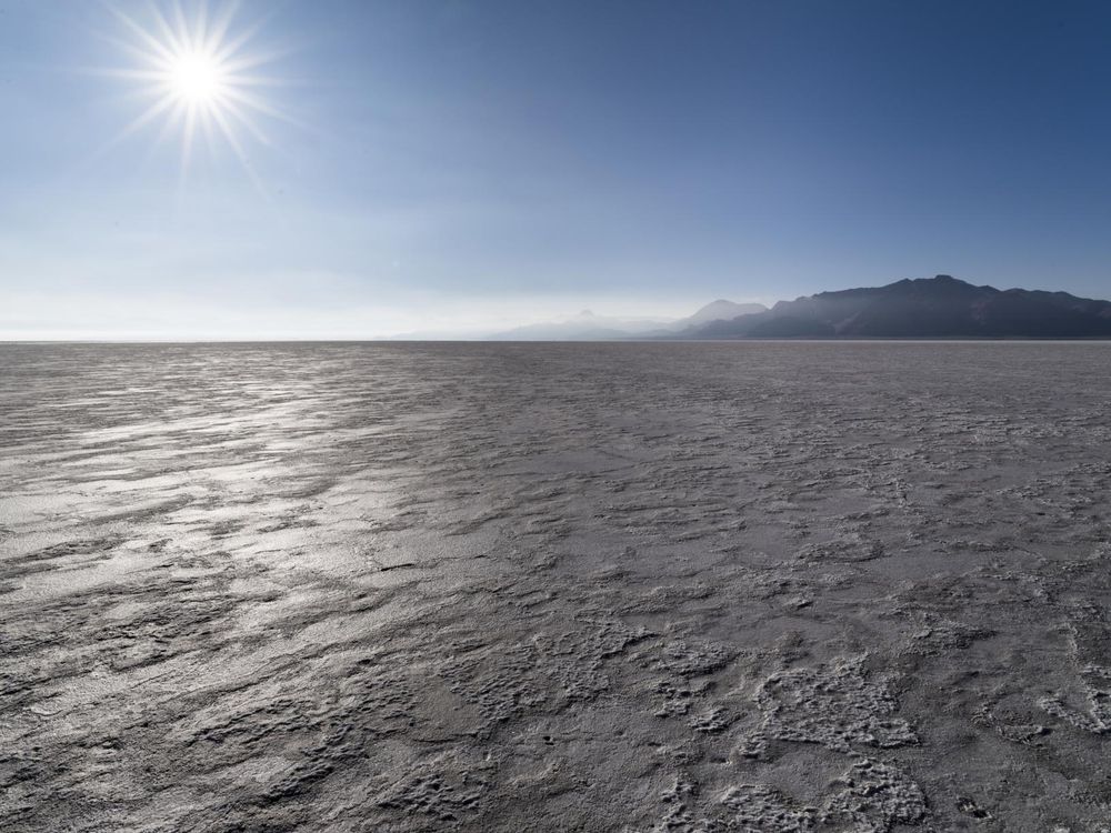 Desert Landscape with Sun Shining Through the Sky near a Hill and Body ...