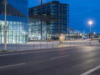 a city street with tall buildings next to a light pole and traffic lights on either side