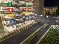 a view of a road and an overpass with traffic passing through it by buildings