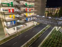 a view of a road and an overpass with traffic passing through it by buildings