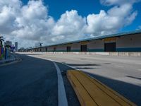 an empty lot with an empty parking lot in the background and clouds in the distance