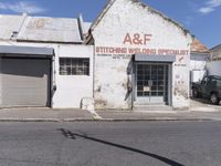 an old building in an abandoned city setting next to a street with signs on it