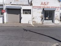 an old building in an abandoned city setting next to a street with signs on it