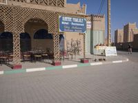 a large building with a blue sign on it that reads the hotel restaurant is sitting empty