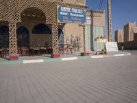 a large building with a blue sign on it that reads the hotel restaurant is sitting empty