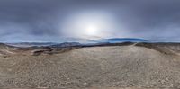 a view from a 360 - angle of an abandoned landscape with rocks and mountains,