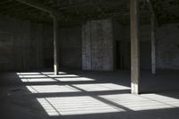 empty brick warehouse space with open floor plan and windows, in the early evening sun