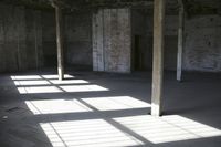 empty brick warehouse space with open floor plan and windows, in the early evening sun