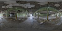 a very big empty building with no windows in it's roof space it was taken in half a fisheye