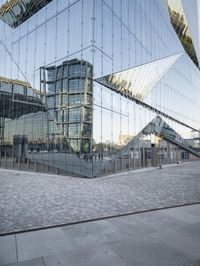 an abstract building reflecting its own reflection on the floor of a stone square and wall