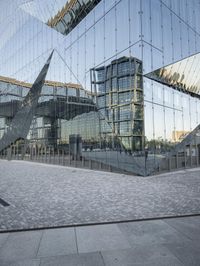 an abstract building reflecting its own reflection on the floor of a stone square and wall