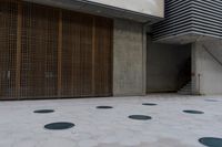 a large parking garage with several different doors to open on the side of it's walk way