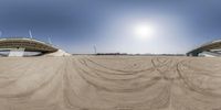 the sand area where the large bridge crosses is an amazing contrast to the sky and earth