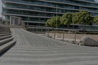 stone steps lead up to the edge of a parking garage in the city street area