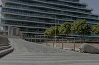 stone steps lead up to the edge of a parking garage in the city street area