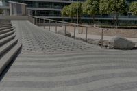 stone steps lead up to the edge of a parking garage in the city street area