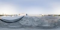 a photo taken on the camera lens of an artisticly designed skate park with concrete ramps