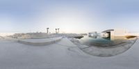 a large empty skateboard park with a pool in it and two stairs in the background