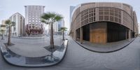 a large circular shaped object on a brick path next to some buildings and palm trees