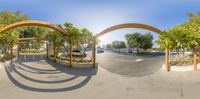 the panorama is 360 - ray rendering of a driveway and walkway in an urban area