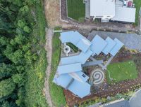 an aerial photo of a house and garden in a neighborhood that includes a circular garden