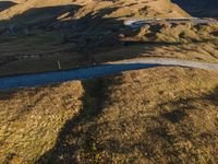 an image of an aerial photo taken on the mountain side with a view of the road passing through