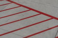 a plane on the runway at an airport in france as the red stripe is painted on the concrete