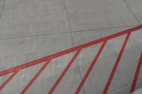 a plane on the runway at an airport in france as the red stripe is painted on the concrete