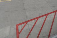 a plane on the runway at an airport in france as the red stripe is painted on the concrete