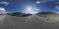 the view of a highway from below a 360 - lens lens in which there is a person on a skateboard