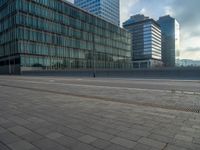 the road is empty on this busy street with the tall building in the background for pedestrians