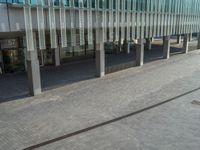 the road is empty on this busy street with the tall building in the background for pedestrians