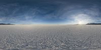 the view from an aircraft of a vast barren plain, with footprints in the snow