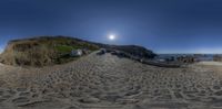 a fisheye lens image showing a path on the beach with boats docked in the water