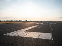 this is an image of a runway in the country side of the sun light shining on the ground