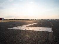 this is an image of a runway in the country side of the sun light shining on the ground