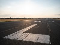 this is an image of a runway in the country side of the sun light shining on the ground