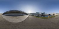 this is a fish eye lens photo taken of a bridge that goes to a parking space