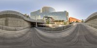 skateboarders are going down a curved sidewalk outside city buildings - urban street view