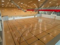 a gym has wood floors and is surrounded by wooden ceiling tiles, and red lines show where it intersects