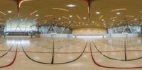 a view looking at a sports hall from a fisheye lens of a basketball court