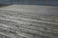 an aerial photo shows wood floor in the day light with weathered planks on it