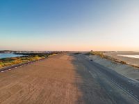 the view of the ocean from the top of a ramp at dusk from a plane