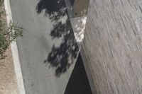 an aerial view of a couple walking across the street near a skateboard ramp at the beach