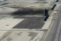 an airplane parked on the tarmac next to a parking lot on the runway at an airport