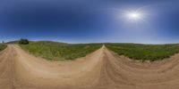 360 - flight over three small sections of dirt road as the sun shines behind them