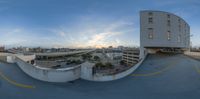 a 360 - vision photograph of the cityscape in this image, a long road with the traffic going underneath it