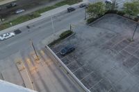 the view from the top floor of a hotel room and garage looking down onto the empty parking lot